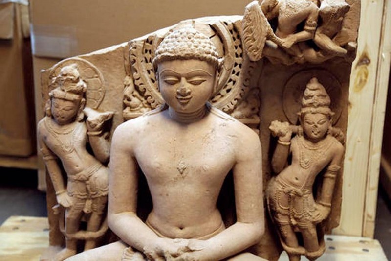 A sandstone statue of Rishabhanata, from Rajasthan or Madhya Pradesh, India, in the 10th century A.D., flanked by a pair of attendants. It is valued at approximately $150,000